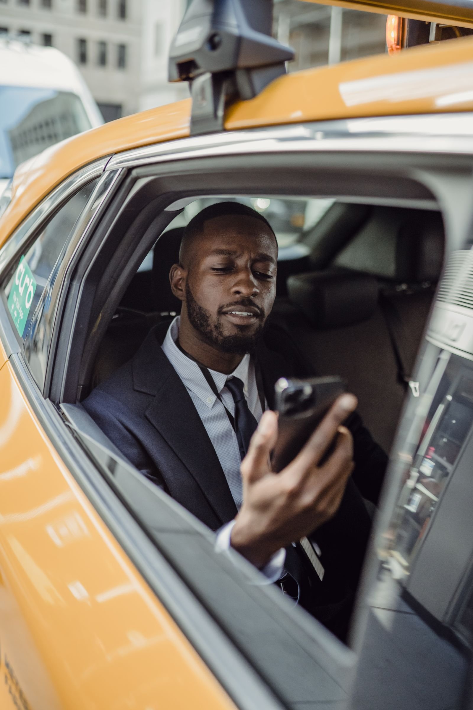 Passager en costume à l'arrière d'un taxi
